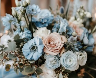 Elegant dusty blue and copper wedding décor featuring a harmonious blend of cool, serene blue tones and warm, inviting copper accents for a timeless winter wedding aesthetic.