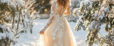 Elegant bride in a January wedding dress standing in a winter landscape, embracing the season's charm and sophistication with cozy, stylish design.