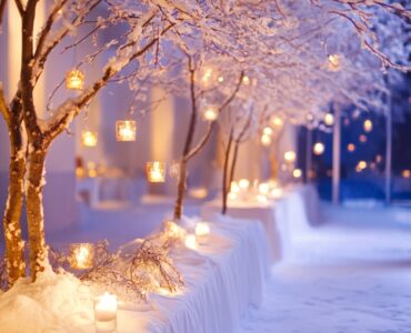 Close-up of a winter wedding venue decorated with snow-covered branches, soft lighting, and cozy details, evoking a warm, romantic January wedding atmosphere.