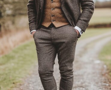 Rustic wedding guest attire for men featuring stylish combinations of tweed blazers, leather boots, and patterned ties, perfect for semi-formal or formal countryside weddings.
