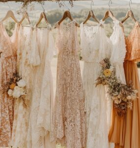 Rustic wedding guest attire displayed against a scenic countryside backdrop, featuring earthy tones, lace details, and flowing fabrics for semi-formal rustic celebrations.