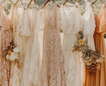 Rustic wedding guest attire displayed against a scenic countryside backdrop, featuring earthy tones, lace details, and flowing fabrics for semi-formal rustic celebrations.
