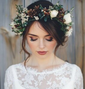 A beautiful winter wedding flower crown with seasonal foliage and delicate flowers, perfect for adding a magical touch to a winter bridal look.