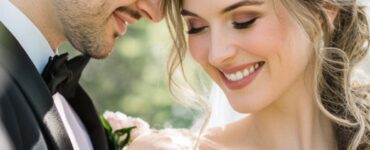 A bride and groom sharing a joyful moment surrounded by blooming spring flowers, highlighting the beauty and romance of a spring wedding celebration.