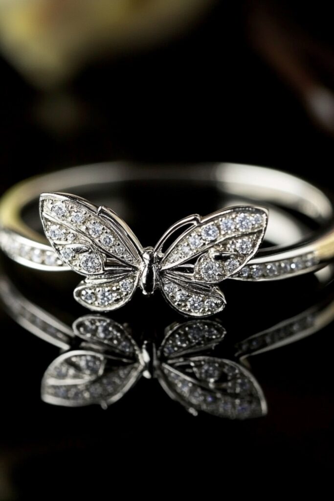Butterfly-inspired wedding ring featuring delicate wing designs adorned with tiny diamonds on a white gold band.