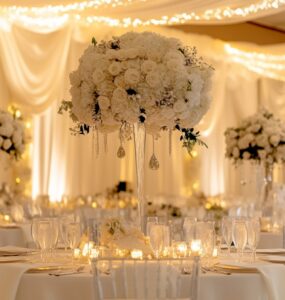 A wedding setup featuring elegant decorations made from affordable Dollar Tree items. The focus is on achieving sophistication through budget-friendly, DIY techniques like centerpieces, backdrops, lighting, and favors.