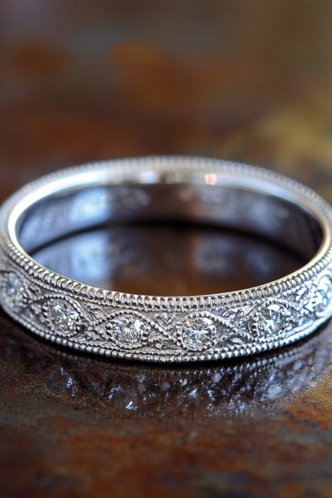 Delicate Edwardian wedding band with intricate filigree work and diamond accents, showcasing early 20th-century elegance.