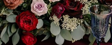 A romantic February wedding setup featuring a color palette swatch with vibrant red, serene blue, elegant purple, and lush green hues, symbolizing love and charm.