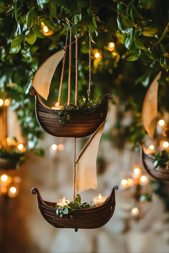 Miniature Viking ships suspended with greenery and candles, adding a whimsical touch to Viking wedding decor ideas.