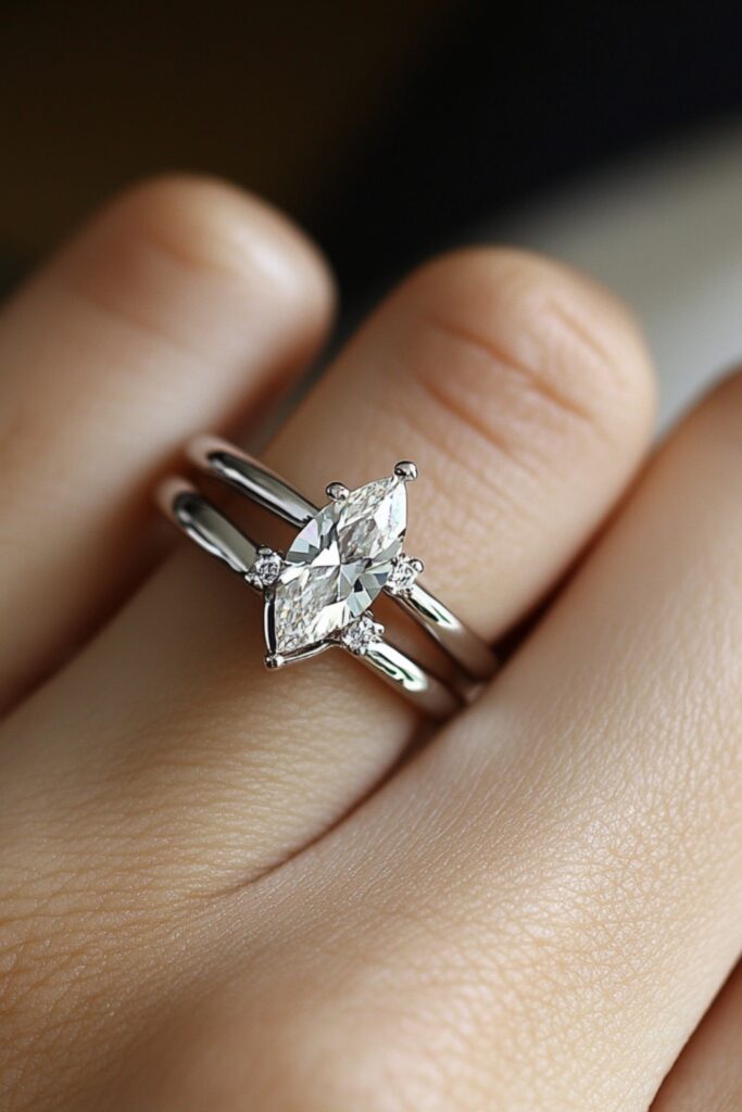 A sleek modern minimalist marquise wedding stack featuring a thin platinum band and a simple marquise engagement ring for understated elegance.