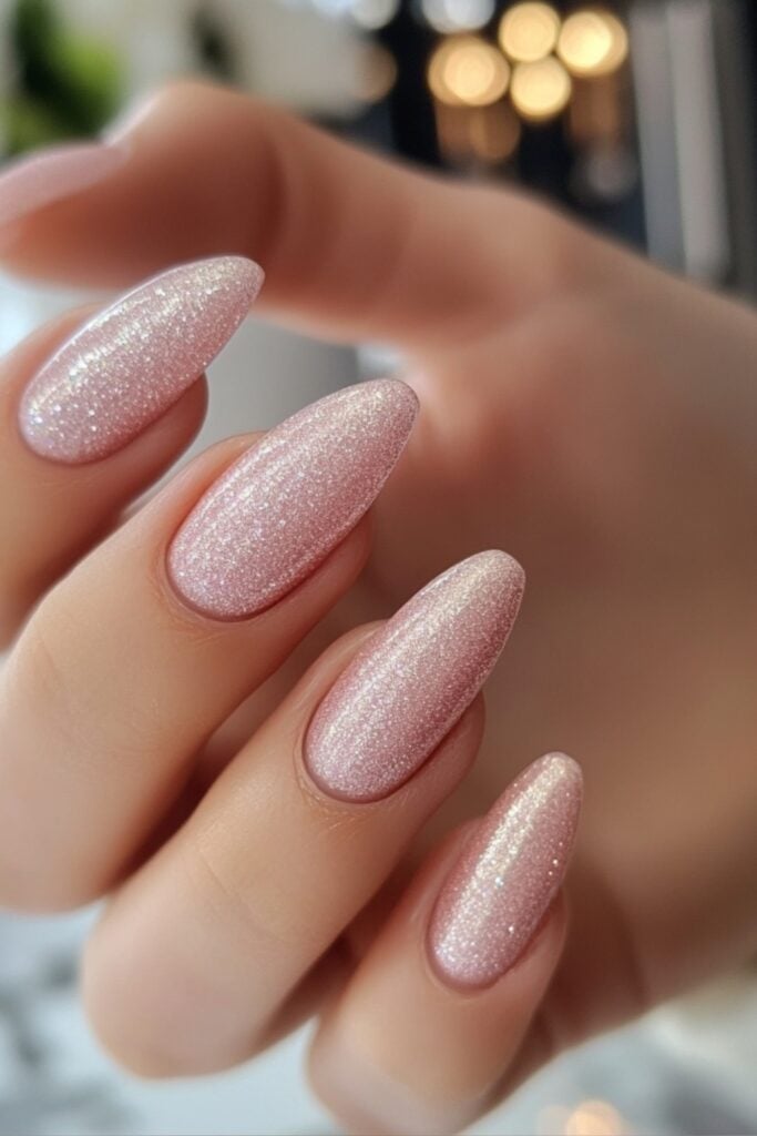 Pearlescent nails in a soft pink hue with a shimmery, glowing effect, radiating elegance and versatility for any wedding setting.