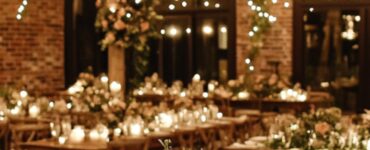An elegant rustic wedding venue adorned with warm string lights and natural wooden elements, creating a cozy and romantic atmosphere for the celebration.