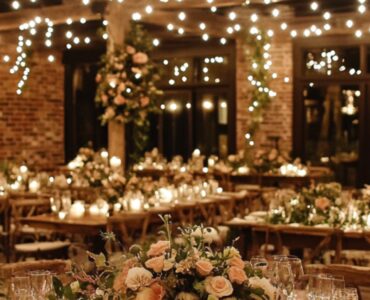 An elegant rustic wedding venue adorned with warm string lights and natural wooden elements, creating a cozy and romantic atmosphere for the celebration.
