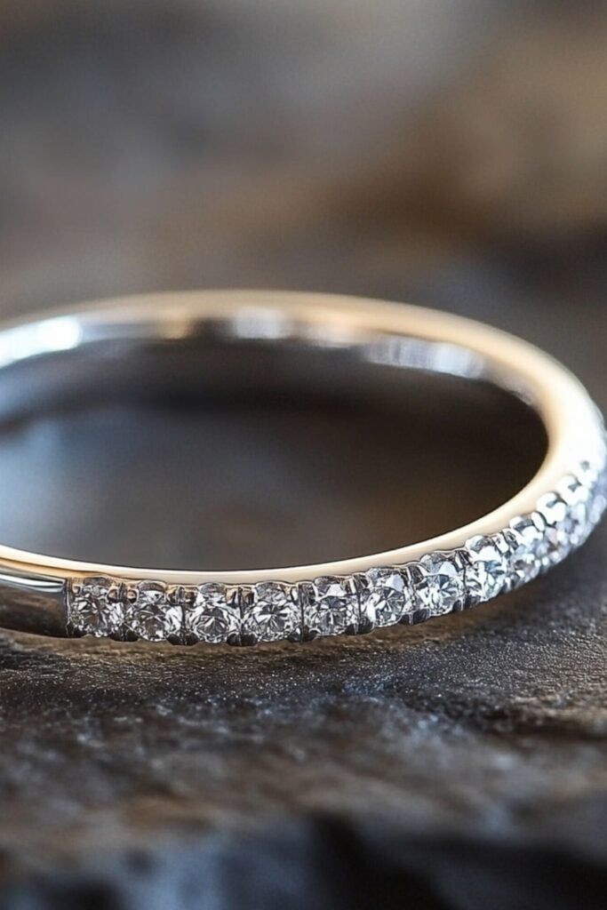 A silver wedding band accented with small sparkling diamonds, showcasing a blend of modern elegance and tradition.