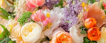 A vibrant spring wedding setup featuring fresh floral arrangements in pastel and bold hues, showcasing tulips, lilacs, and other seasonal blooms that create a romantic and colorful atmosphere.