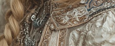 Close-up of a bride in a Viking wedding traditional dress, featuring intricate embroidery, fur accents, and Norse-inspired details, set against a backdrop of lush Scandinavian nature.