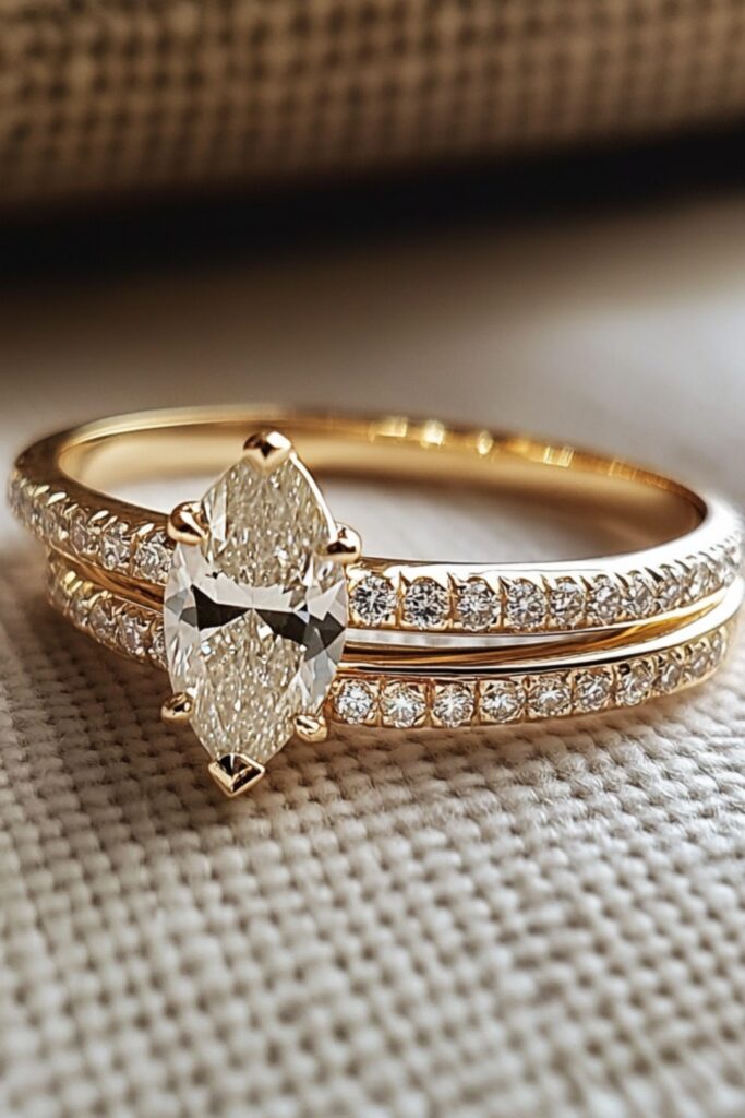 A marquise engagement ring paired with a curved diamond pavé wedding band, showcasing a seamless, harmonious design for a timeless and elegant wedding stack.