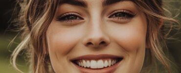 Photo of a smiling wedding guest in natural light, showcasing elegant yet understated makeup, perfect for celebrating the happy couple’s special day.
