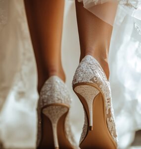 Close-up of a bride’s feet in stylish wedding heels as she steps forward, symbolizing confidence and the start of a beautiful journey.