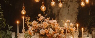An intimate wedding setup with a small group of guests, featuring a romantic outdoor dinner table adorned with candles, flowers, and meaningful personal touches.