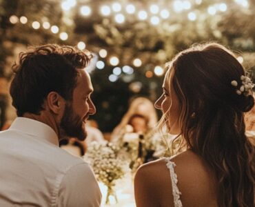 A couple enjoying a backyard wedding, surrounded by lush greenery and fairy lights, with guests dressed in stylish yet comfortable outfits.