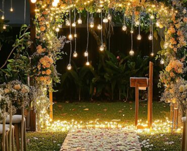 A beautifully decorated backyard with fairy lights, a wooden arch adorned with flowers, and chairs set up for a wedding ceremony, evoking an intimate and magical atmosphere.