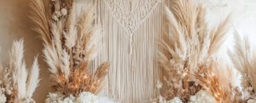 A romantic bohemian wedding ceremony setup featuring an elegant backdrop with natural elements, including pampas grass, macramé details, and hanging fairy lights, creating a whimsical atmosphere.