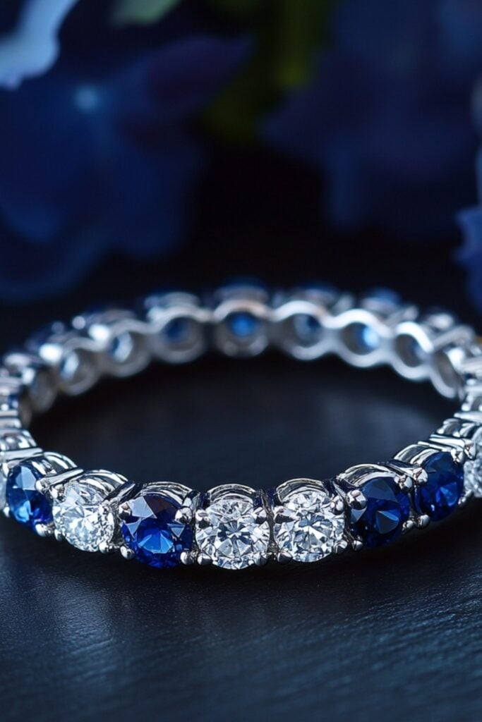 Elegant eternity band featuring alternating sapphires and diamonds, glimmering under natural light.