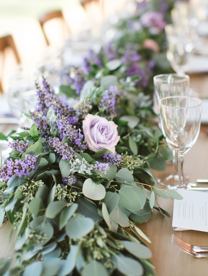 Fragrant lavender and eucalyptus garlands draped across tables, creating a lush, nature-inspired centerpiece that adds a calming and organic touch to a spring wedding.