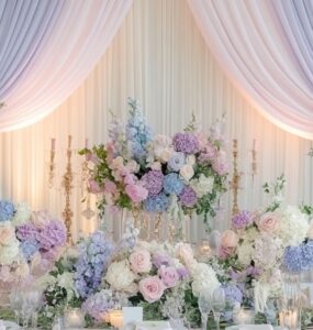 Soft pastel wedding setup with blush pink, lavender, mint green, and powder blue elements, including floral arrangements, table décor, and elegant backdrops, creating a serene and romantic ambiance.