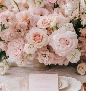 Wedding décor inspiration showcasing soft blush floral arrangements, pink invitations, and romantic accents that set the tone for a pink wedding theme.