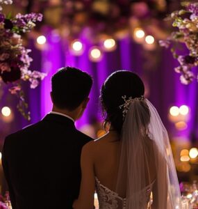 A breathtaking wedding setup with purple and burgundy accents, luxurious floral arrangements, candlelit decor, and an elegantly dressed couple celebrating their love.