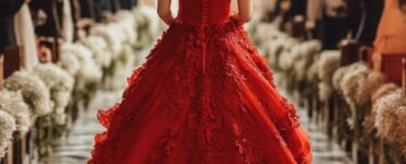 Full-length view of a bride walking down the aisle in a red wedding dress, symbolizing bold beauty and unforgettable style.