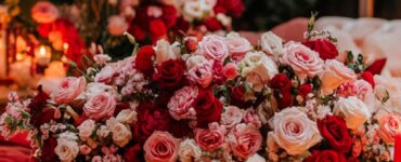 A romantic Valentine’s Day setup with soft pink and red décor, cozy lighting, and elegant floral arrangements, symbolizing love and connection.