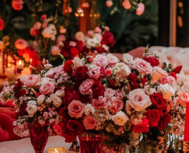 A romantic Valentine’s Day setup with soft pink and red décor, cozy lighting, and elegant floral arrangements, symbolizing love and connection.