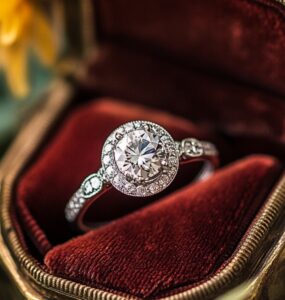 Elegant vintage engagement ring resting in an heirloom box, symbolizing a timeless love story, featuring old-world craftsmanship and a sparkling center stone.